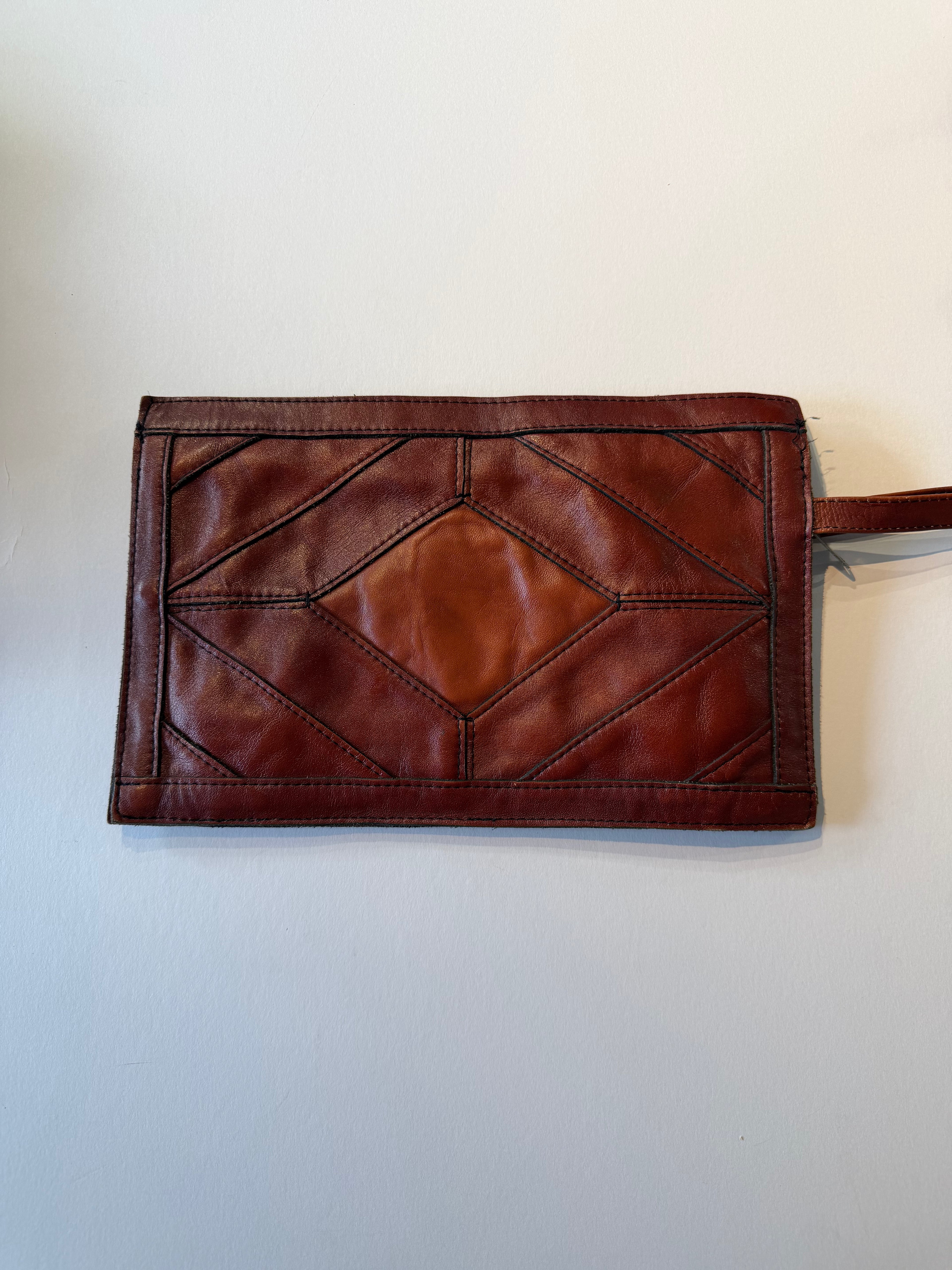 Vintage leather patchwork wristlet clutch bag.