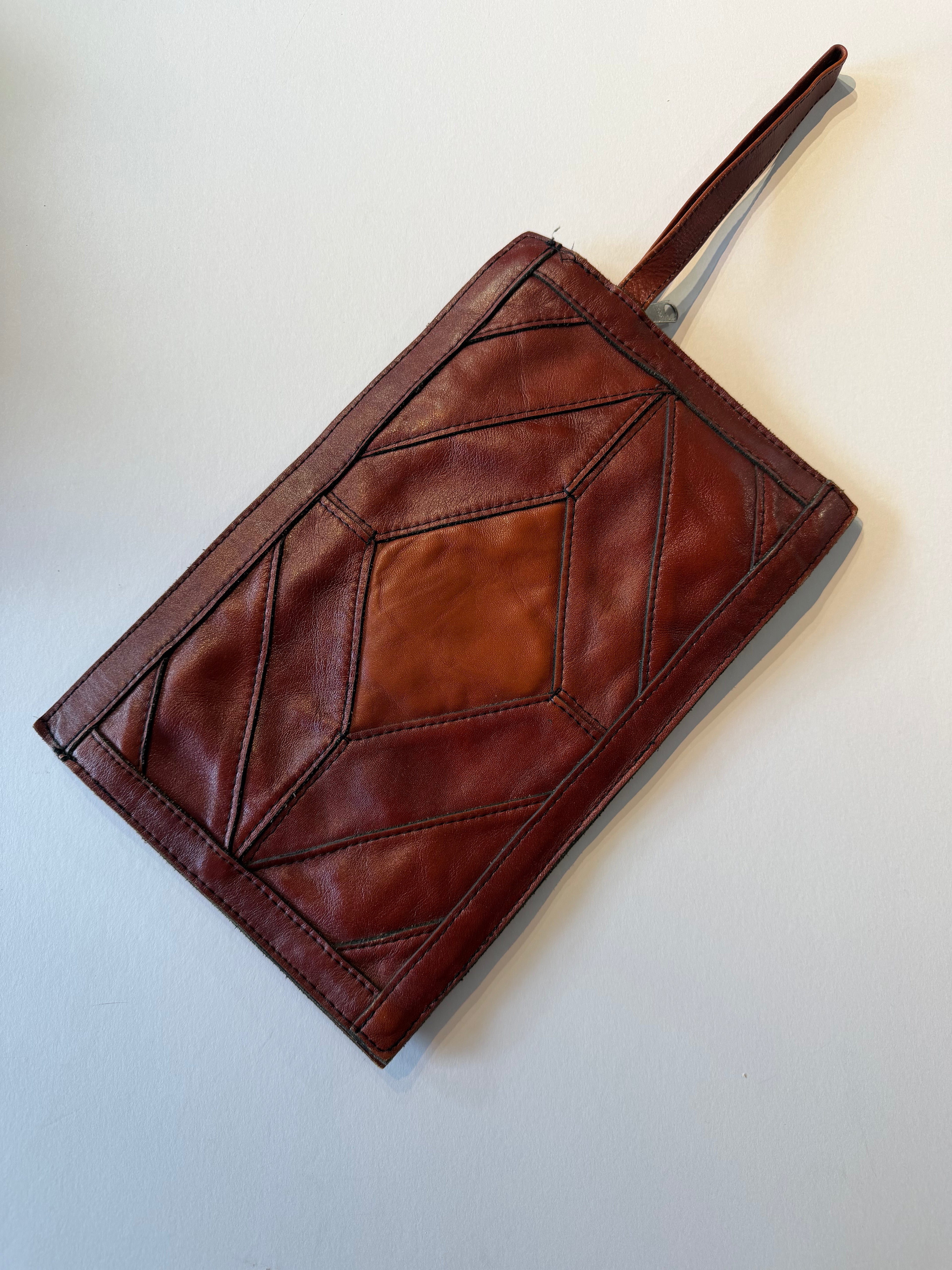 Vintage leather patchwork wristlet clutch bag.